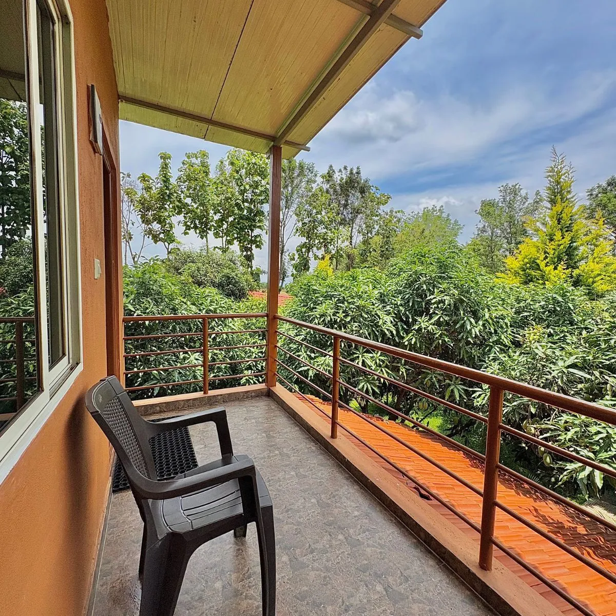 Balcony seating at Bird Lounge room overlooking greenery