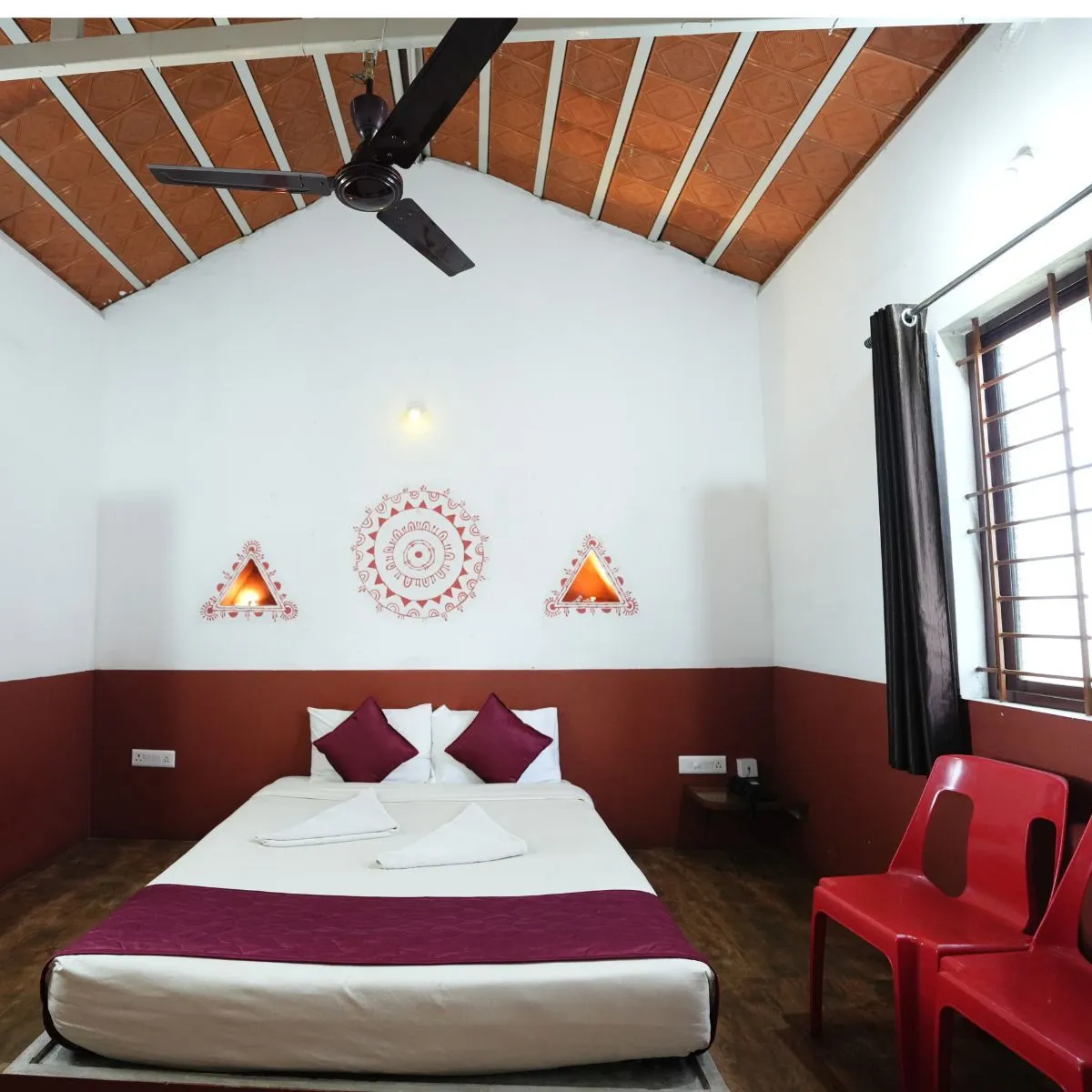 Couple hut interior with double bed and wooden ceiling