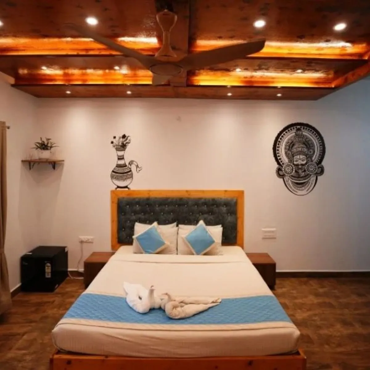 Cob house bed with towel setup and wooden ceiling lighting